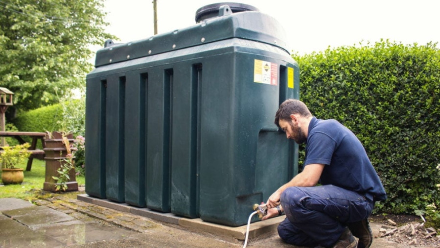 OilMaxx employee installing a fuel tank in someones garden