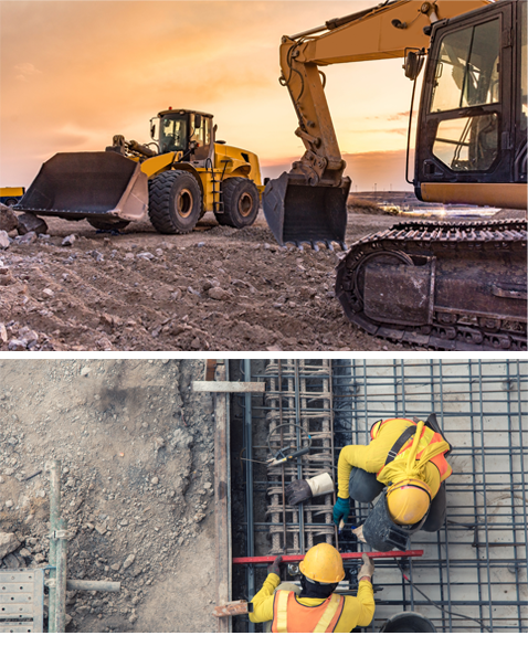 Diggers working on a site with the sun going down and two workers installing pipes